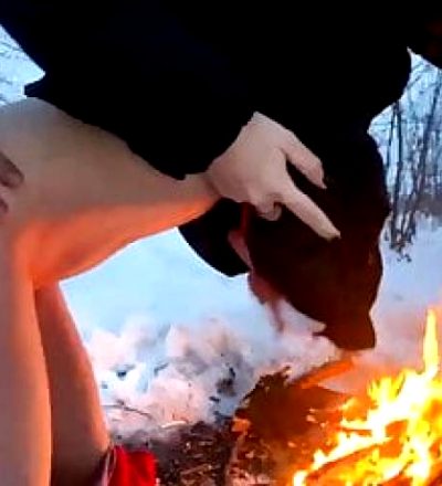 A guy and a girl fuck in the winter by the fire